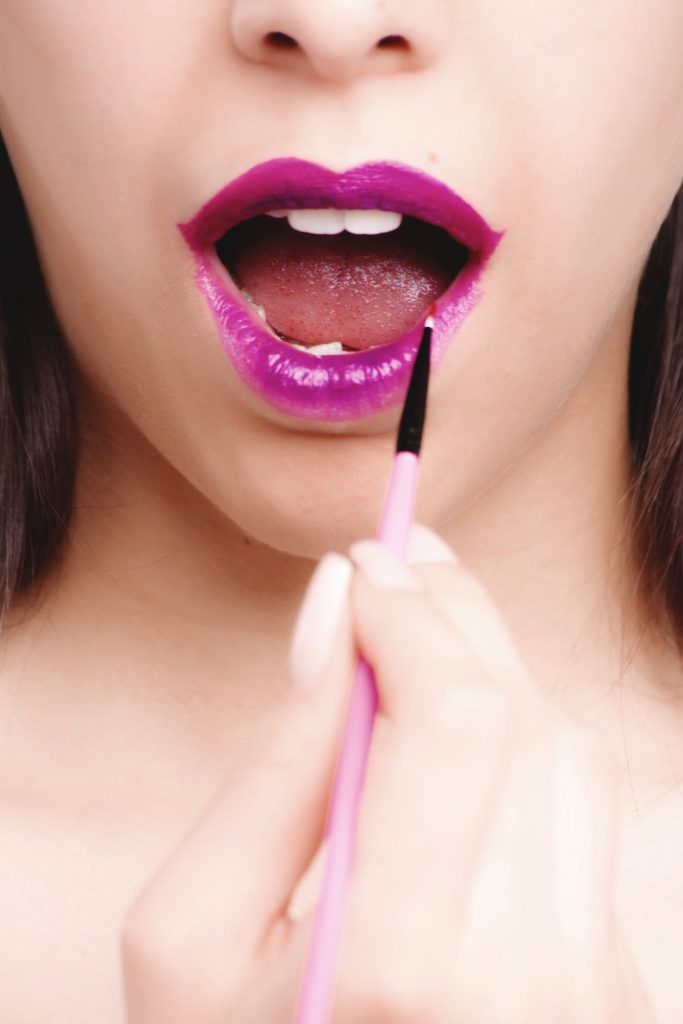 woman applying lipstick
